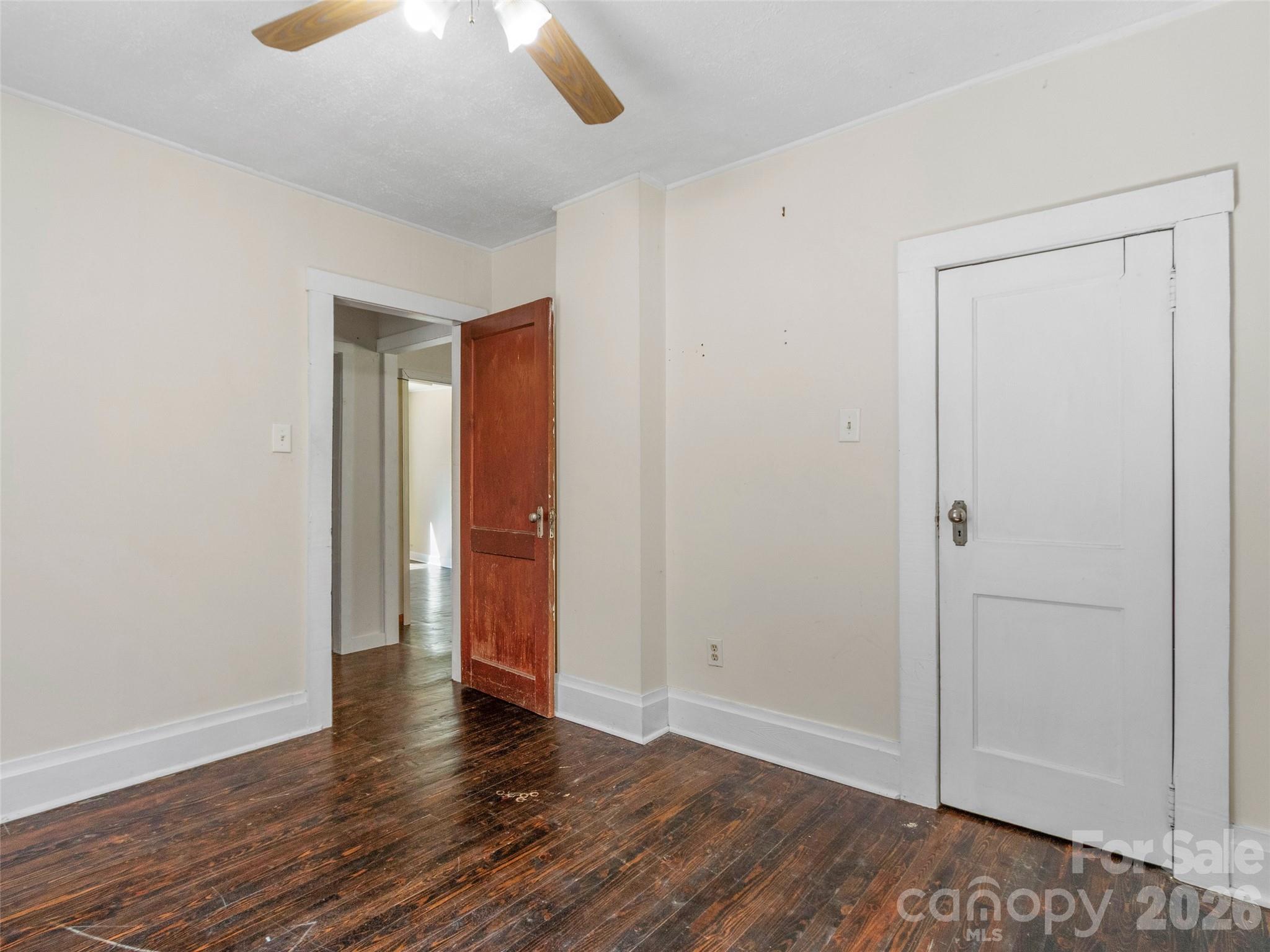 689 Bald Mountain Road Burnsville, NC 28714 - Photo 12 of 21 an empty room with wooden floor and windows