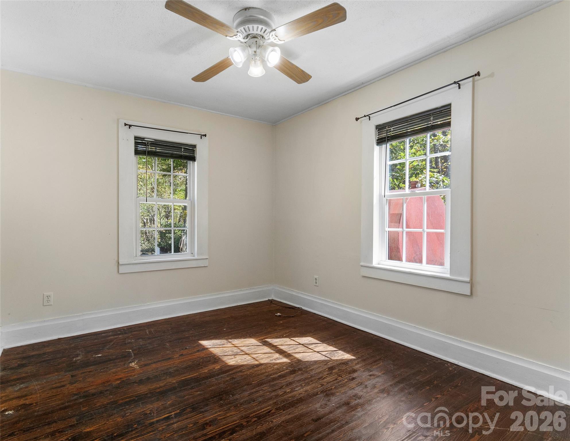 689 Bald Mountain Road Burnsville, NC 28714 - Photo 13 of 21 a view of an empty room with wooden floor and a window