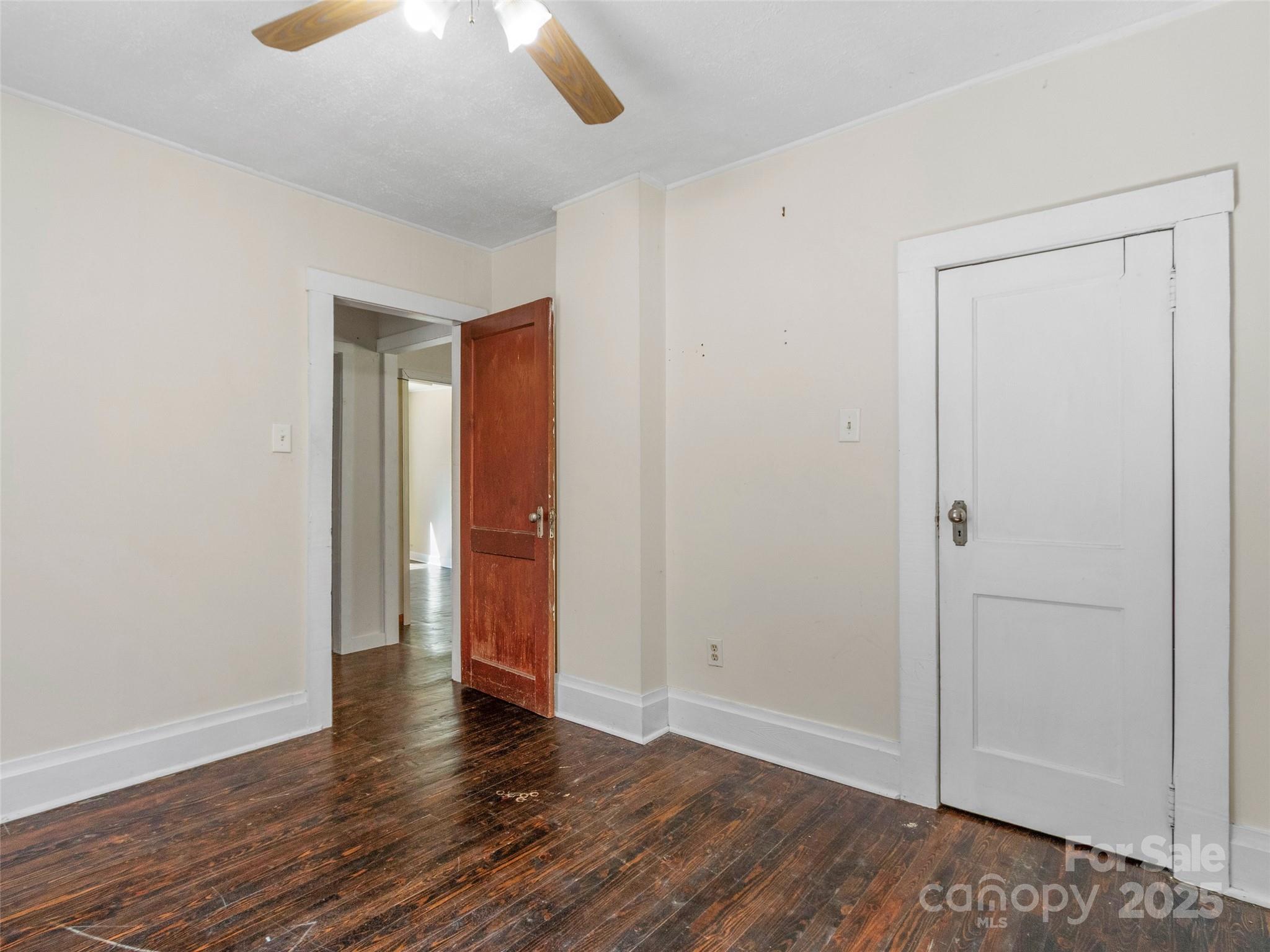689 Bald Mountain Road Burnsville, NC 28714 - Photo 13 of 21 a view of an empty room with wooden floor