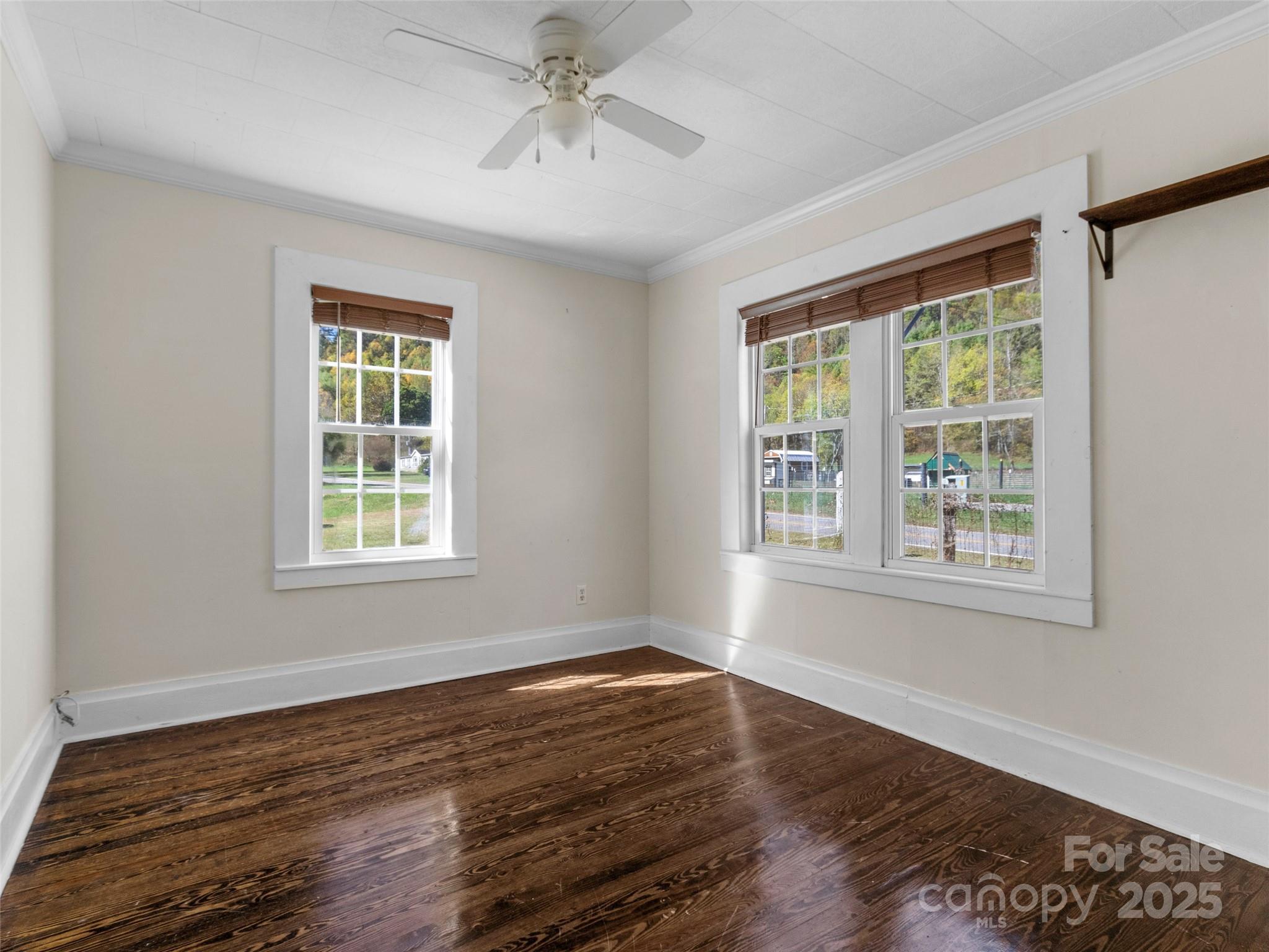 689 Bald Mountain Road Burnsville, NC 28714 - Photo 15 of 21 a view of an empty room with wooden floor and a window