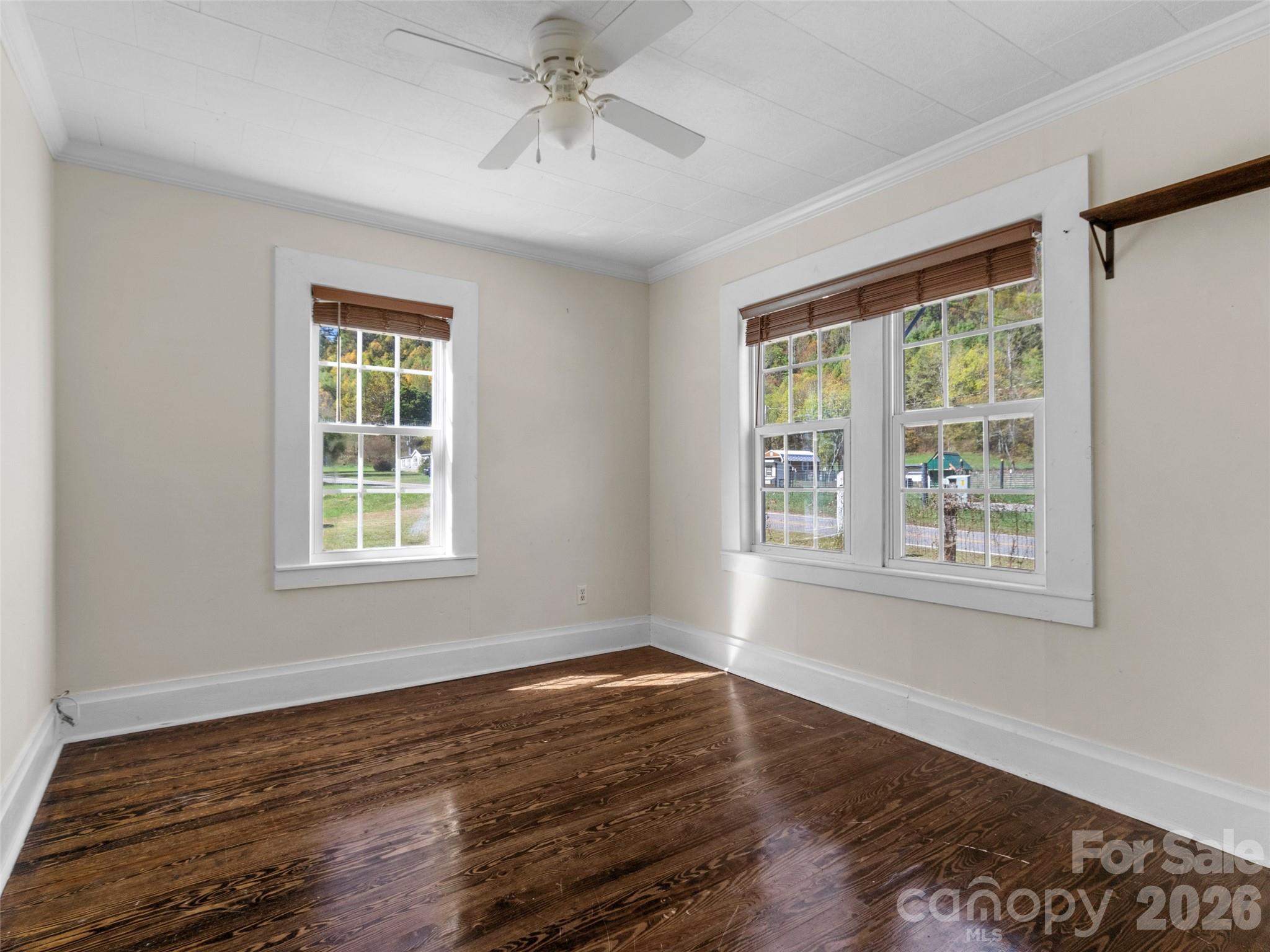 689 Bald Mountain Road Burnsville, NC 28714 - Photo 15 of 21 a view of an empty room with wooden floor and a window