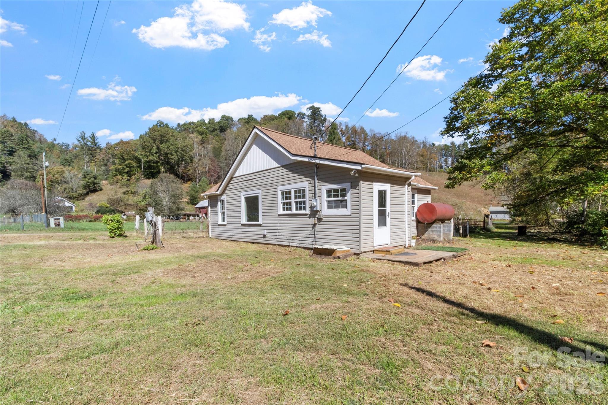 689 Bald Mountain Road Burnsville, NC 28714 - Photo 3 of 21 a front view of a house with a yard and garage