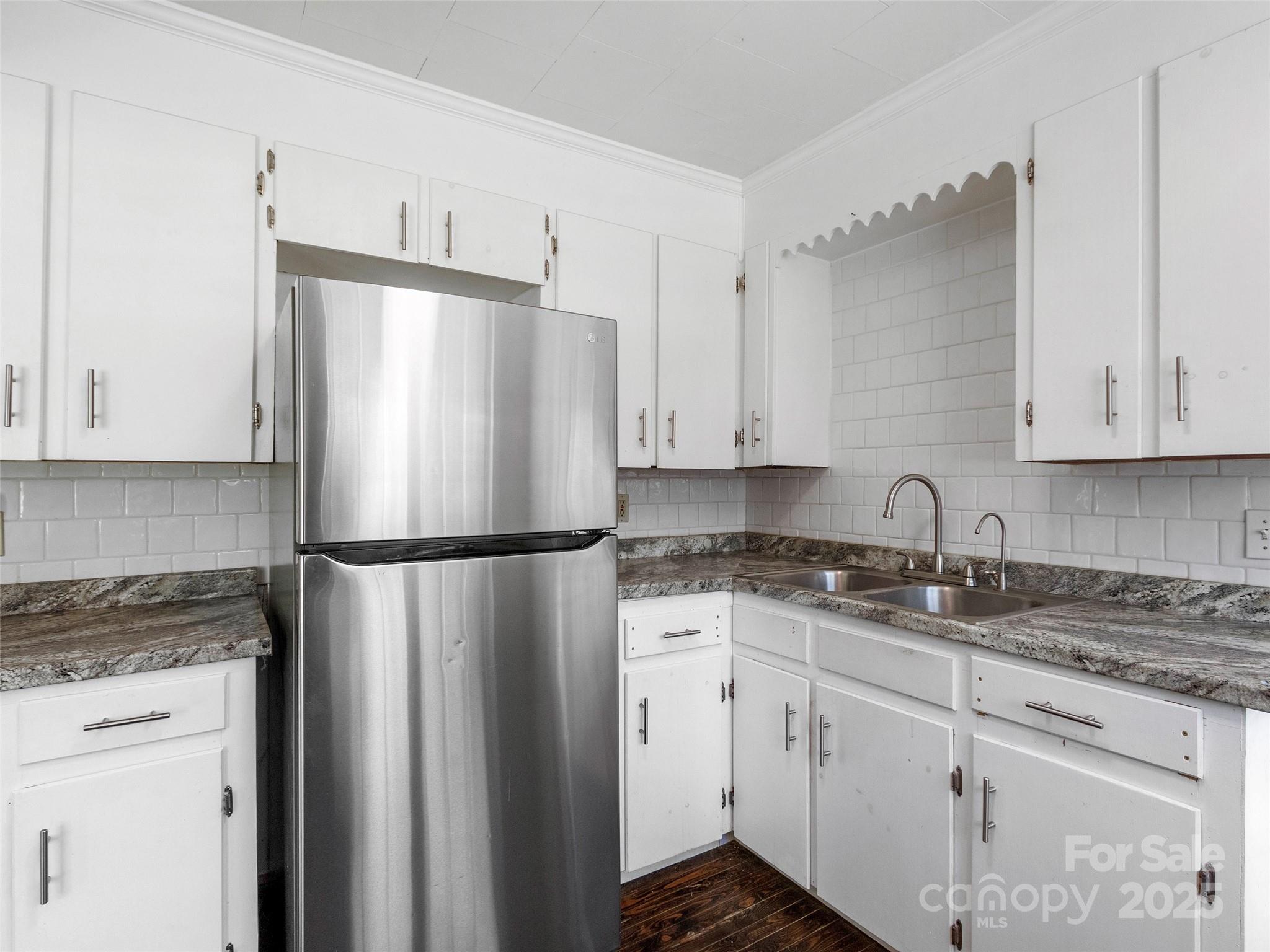 689 Bald Mountain Road Burnsville, NC 28714 - Photo 5 of 21 a white refrigerator freezer sitting inside of a kitchen