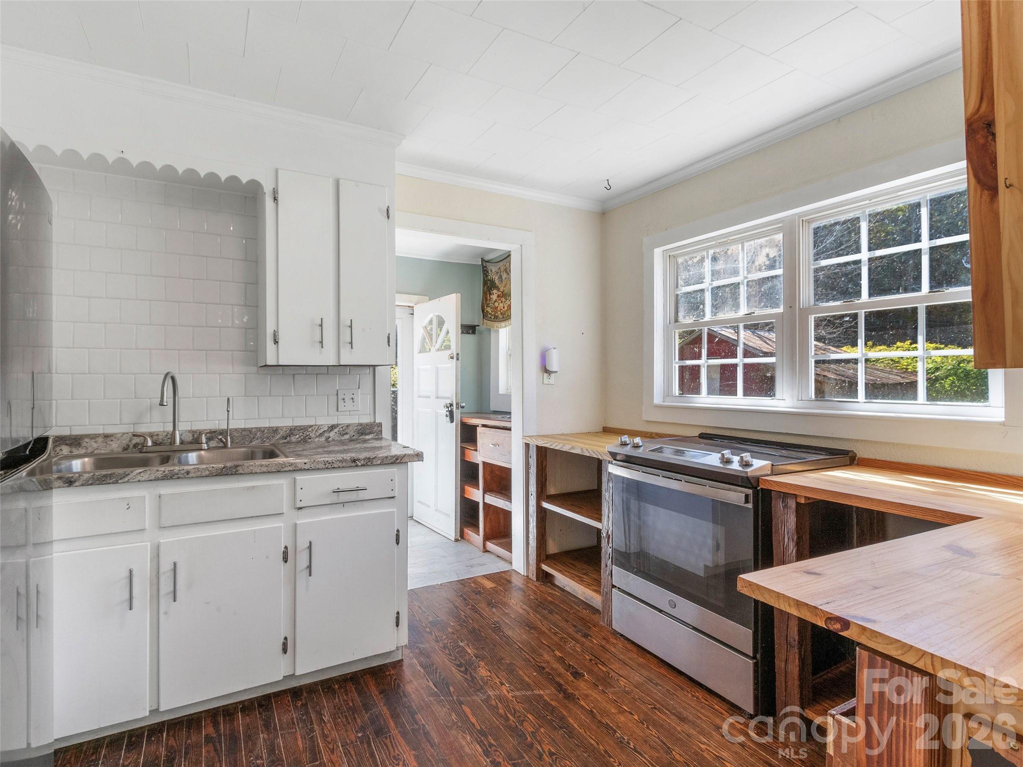 689 Bald Mountain Road Burnsville, NC 28714 - Photo 6 of 21 a kitchen with stainless steel appliances granite countertop a stove and cabinets