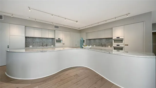 a view of kitchen with stainless steel appliances granite countertop refrigerator sink and stove
