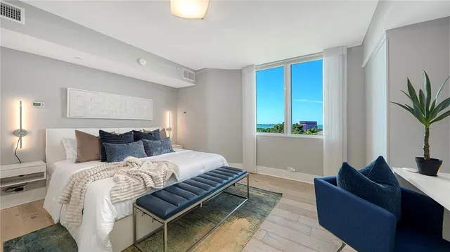 a bedroom with bed couch and window