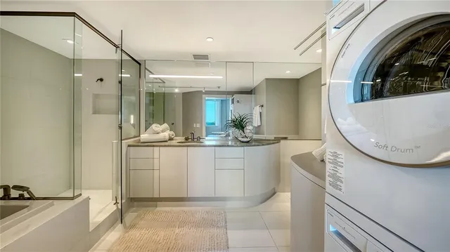 a bathroom with a sink mirror vanity and bathtub