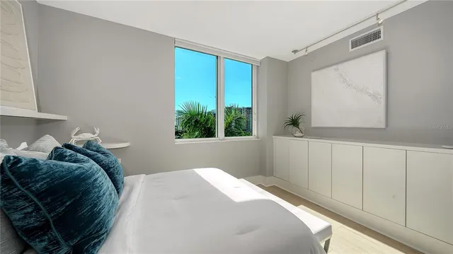 a bed sitting in a bedroom next to a window