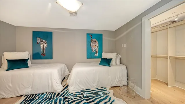 a bedroom with two beds and a window