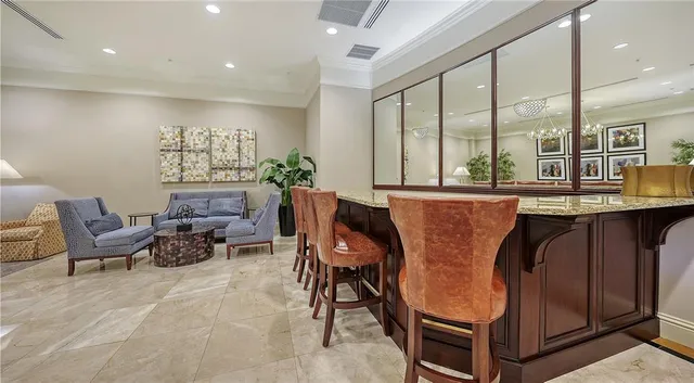 a living room with furniture and large windows