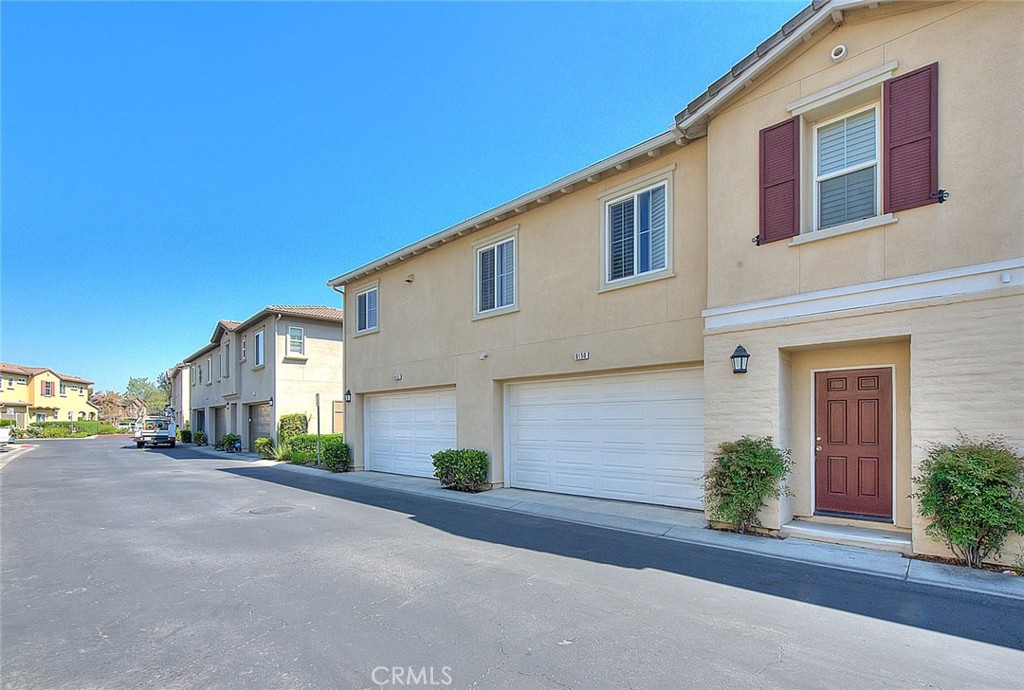 8150 West Preserve Loop Chino, CA 91708 - Photo 5 of 51 a front view of a house with a yard and garage