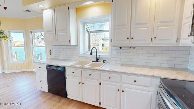 a kitchen with white cabinets and a sink