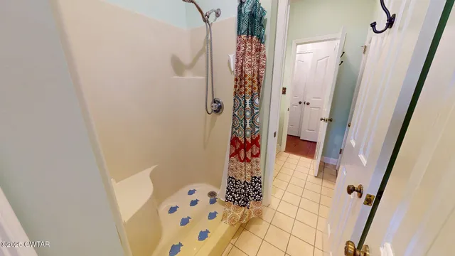 a bathroom with a sink and shower curtain