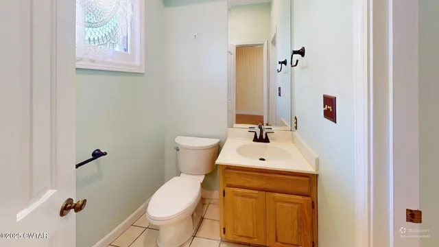 a bathroom with a sink toilet and mirror