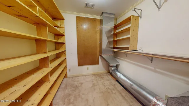 a view of walk in closet with empty racks