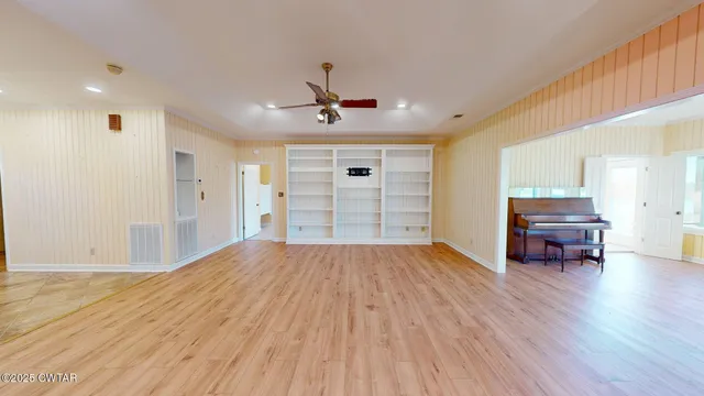 a view of empty room with wooden floor and cabinet