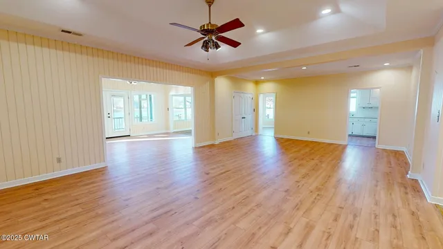 a view of an empty room and wooden floor