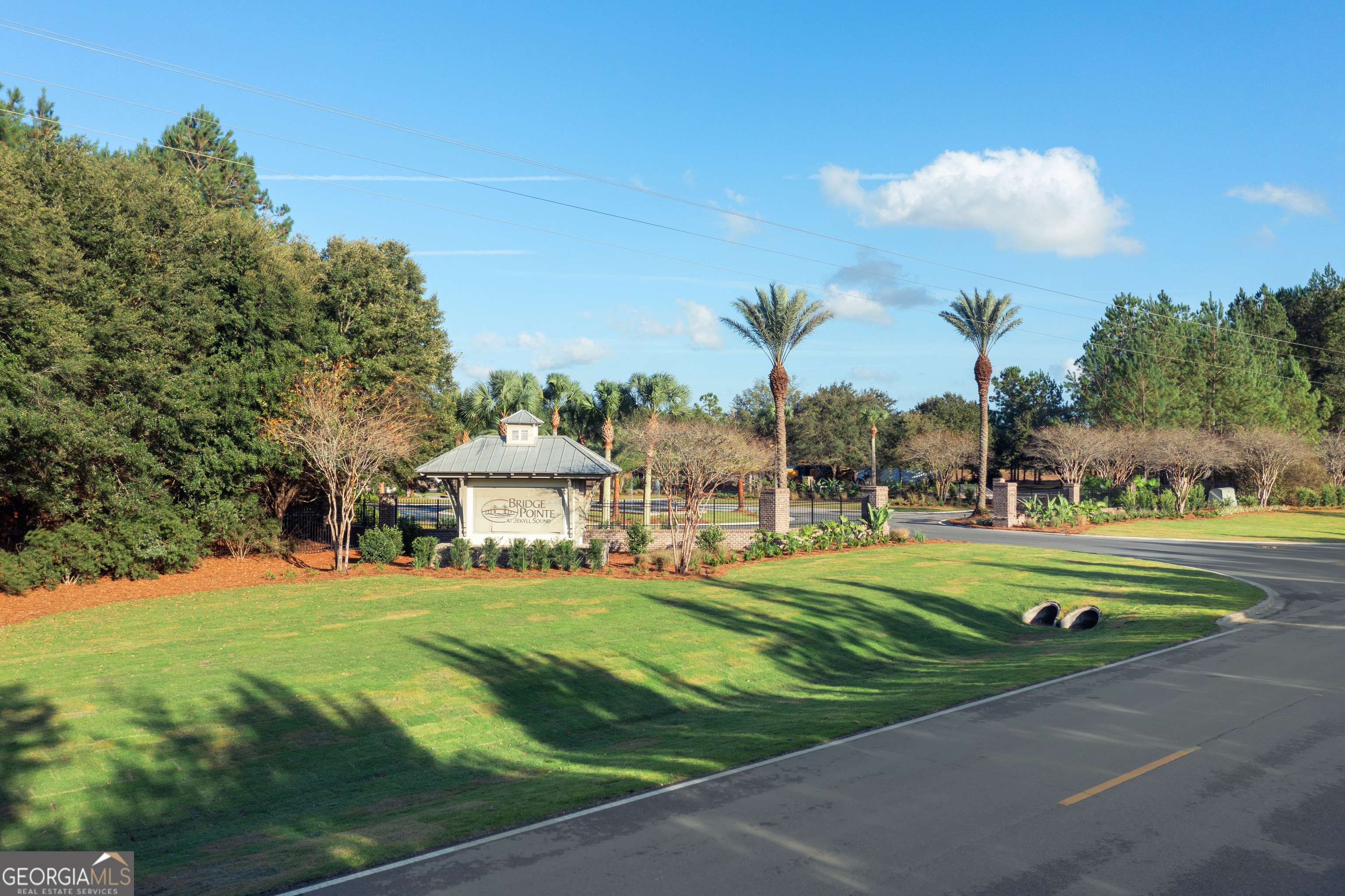 Lot 547 Beacon Pointe Parkway Waverly, GA 31565 - Photo 10 of 16 a front view of a house with a big yard and potted plants
