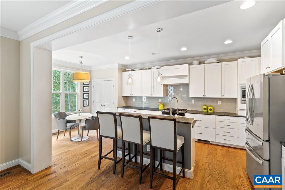 1728 Bending Branch Road Charlottesville, VA 22901 - Photo 13 of 36 a kitchen with granite countertop a table chairs microwave and cabinets