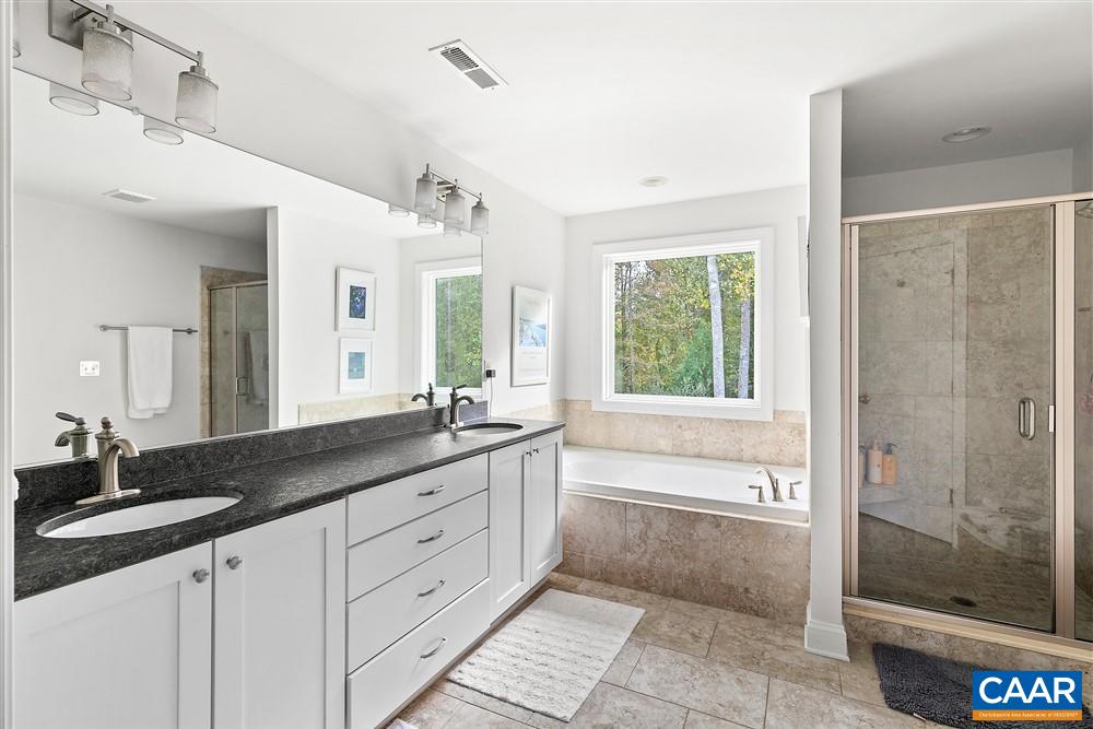 1728 Bending Branch Road Charlottesville, VA 22901 - Photo 22 of 36 a bathroom with a granite countertop sink a large mirror a shower and a bathtub