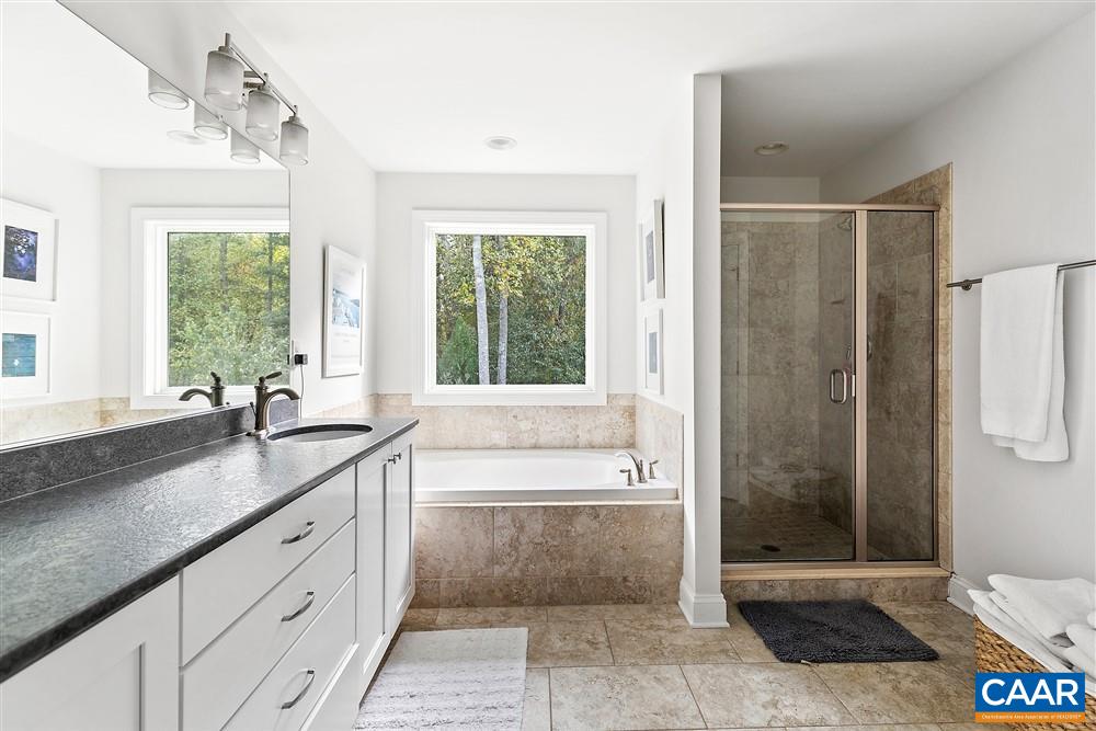 1728 Bending Branch Road Charlottesville, VA 22901 - Photo 23 of 36 a spacious bathroom with a granite countertop tub sink and shower