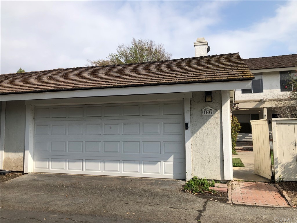 a view of a house with a wooden fence