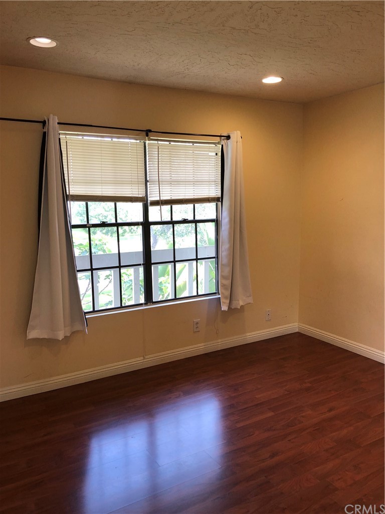 142 West Yale Loop Irvine, CA 92604 - Photo 21 of 28 a view of an empty room with wooden floor and a window