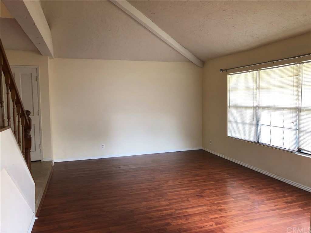 142 West Yale Loop Irvine, CA 92604 - Photo 7 of 28 a view of an empty room with wooden floor and a window