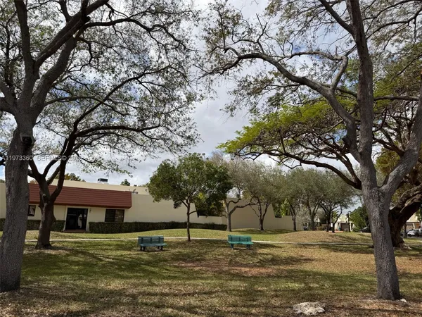 a white house that has a tree in front of it