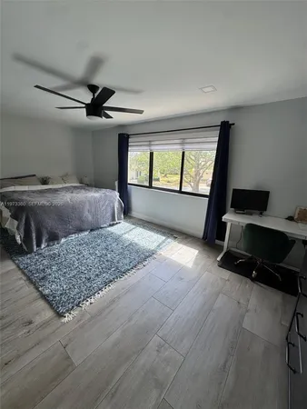 a bed room with furniture and window