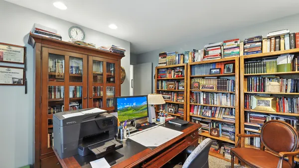 a view of a workspace with bookshelf