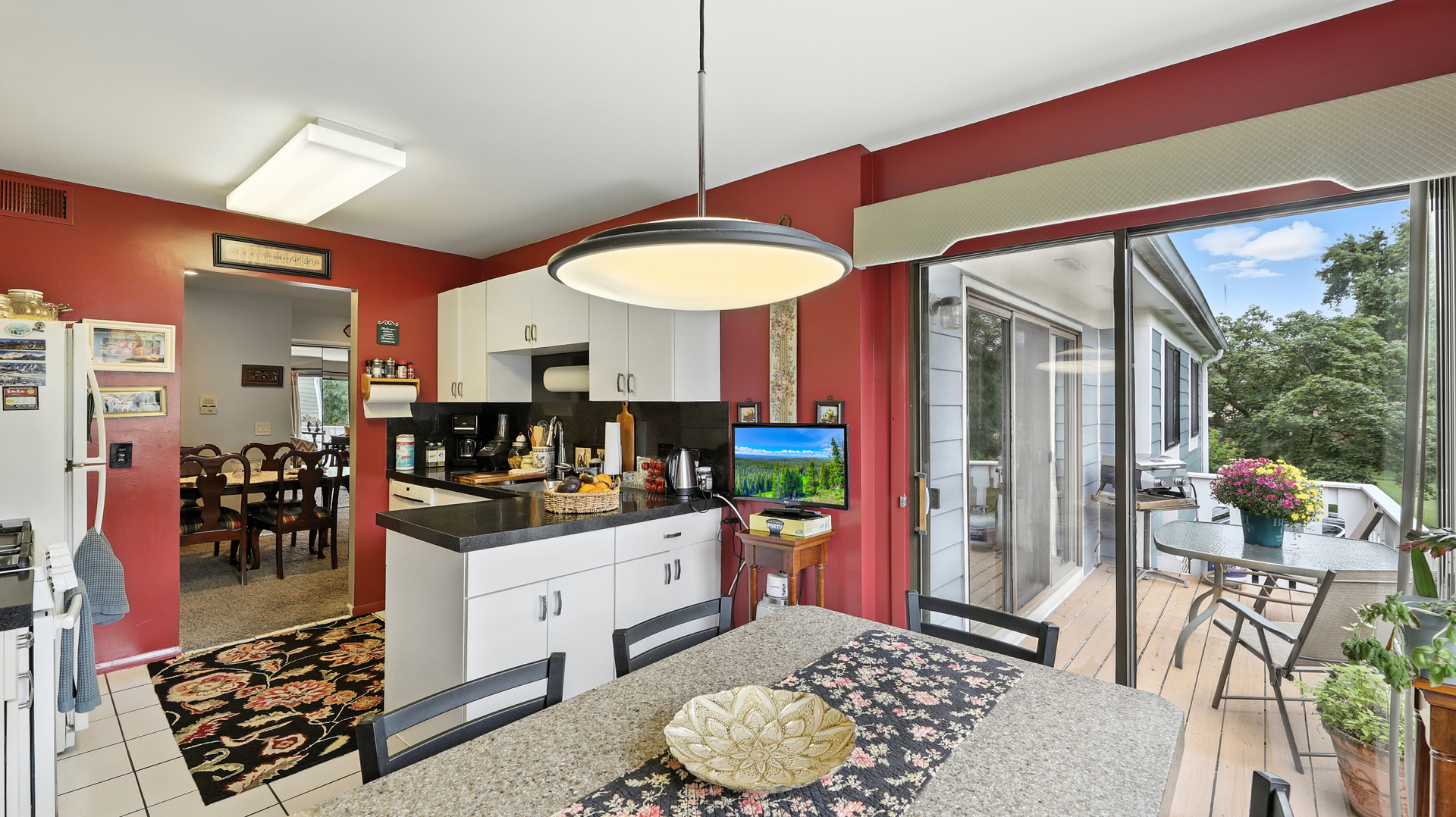 550 Greystone Lane, Unit A2 Wheeling, IL 60090 - Photo 4 of 15 a kitchen with stainless steel appliances kitchen island granite countertop a stove a refrigerator and a dining table with the kitchen view