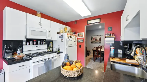 a kitchen with stainless steel appliances kitchen island granite countertop a sink and cabinets