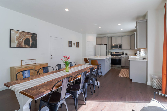 373 Quartz Road Tooele, UT 84074 - Photo 18 of 38 Open-concept living space with dark wood-finish flooring, recessed lighting, and a white interior door