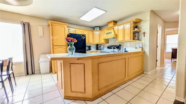 a hall view with a sink a mirror and a dining table with chairs