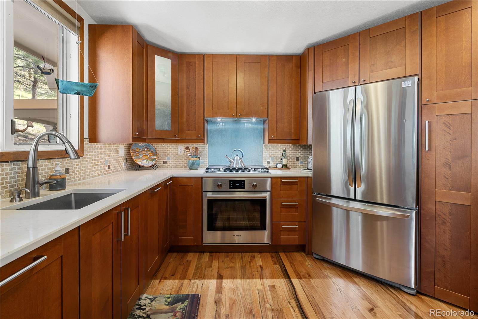 107 Elk Drive Evergreen, CO 80439 - Photo 16 of 45 a kitchen with a refrigerator sink and cabinets
