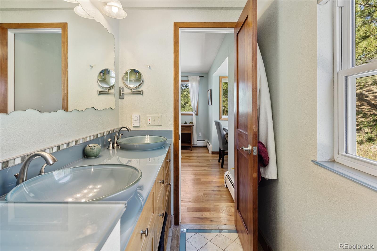 107 Elk Drive Evergreen, CO 80439 - Photo 20 of 45 a en suite bathroom with a sink and a mirror