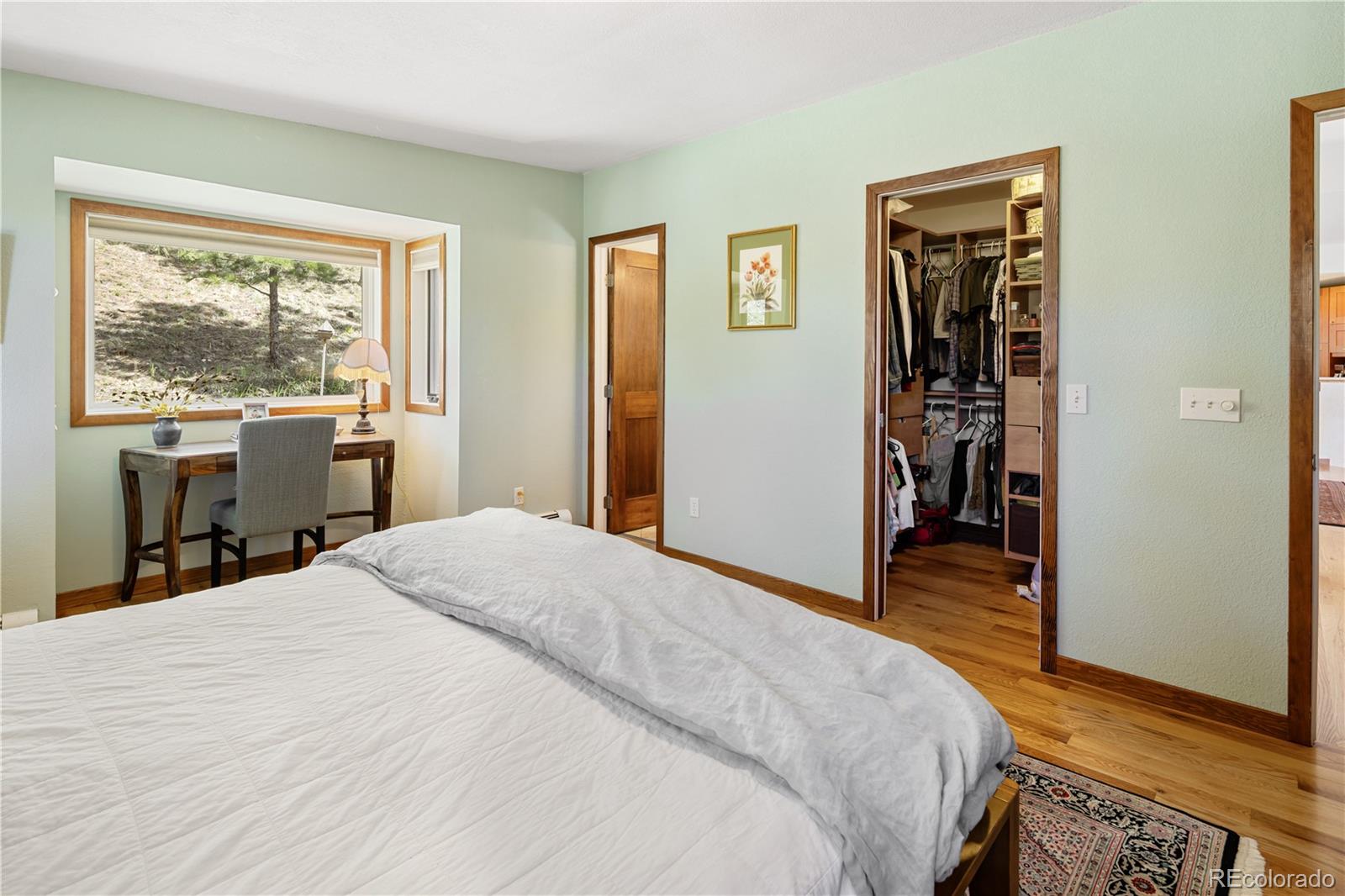 107 Elk Drive Evergreen, CO 80439 - Photo 23 of 45 a bedroom with a large bed and a window