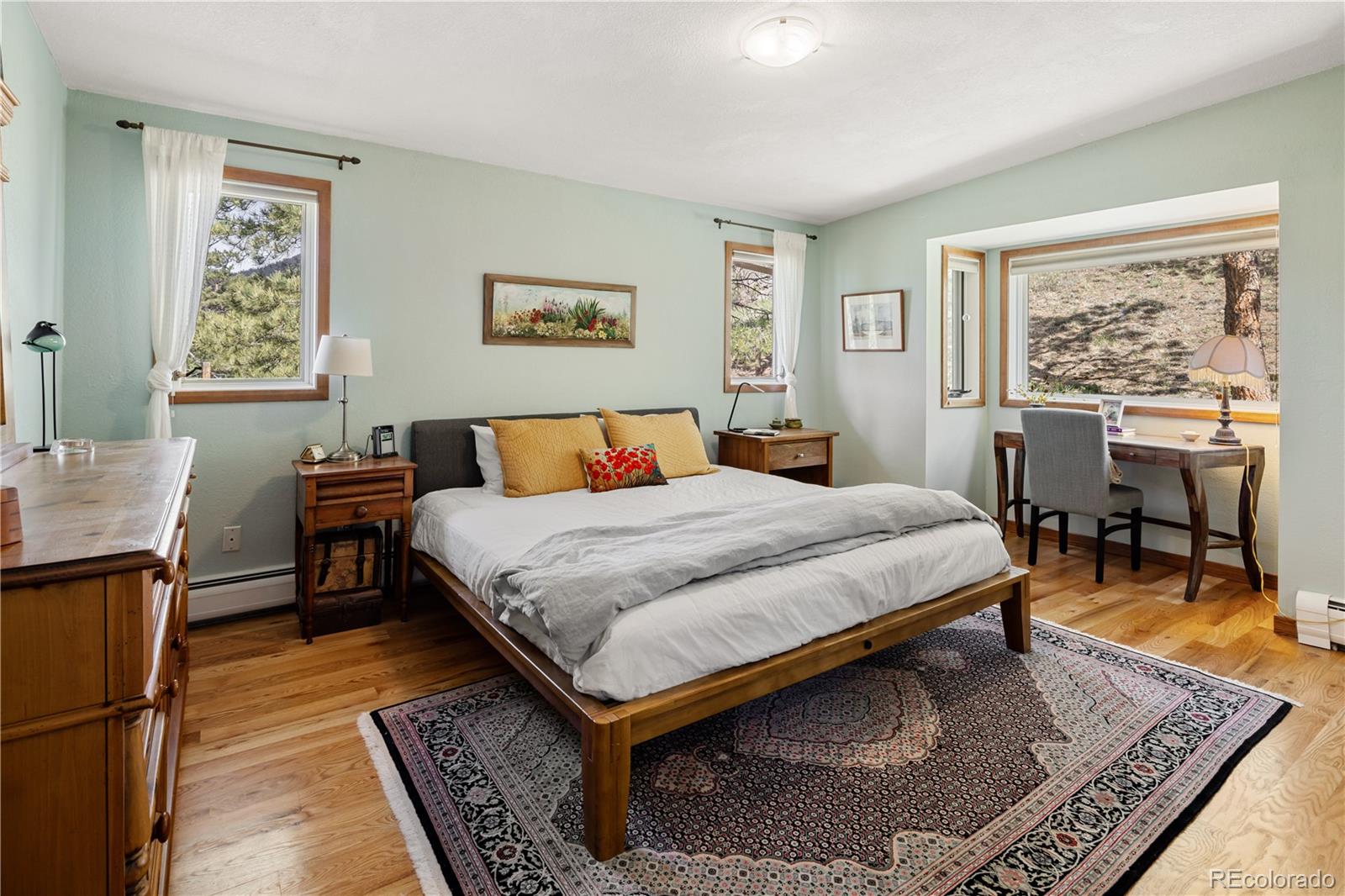 107 Elk Drive Evergreen, CO 80439 - Photo 24 of 45 a bedroom with a bed a table and chair