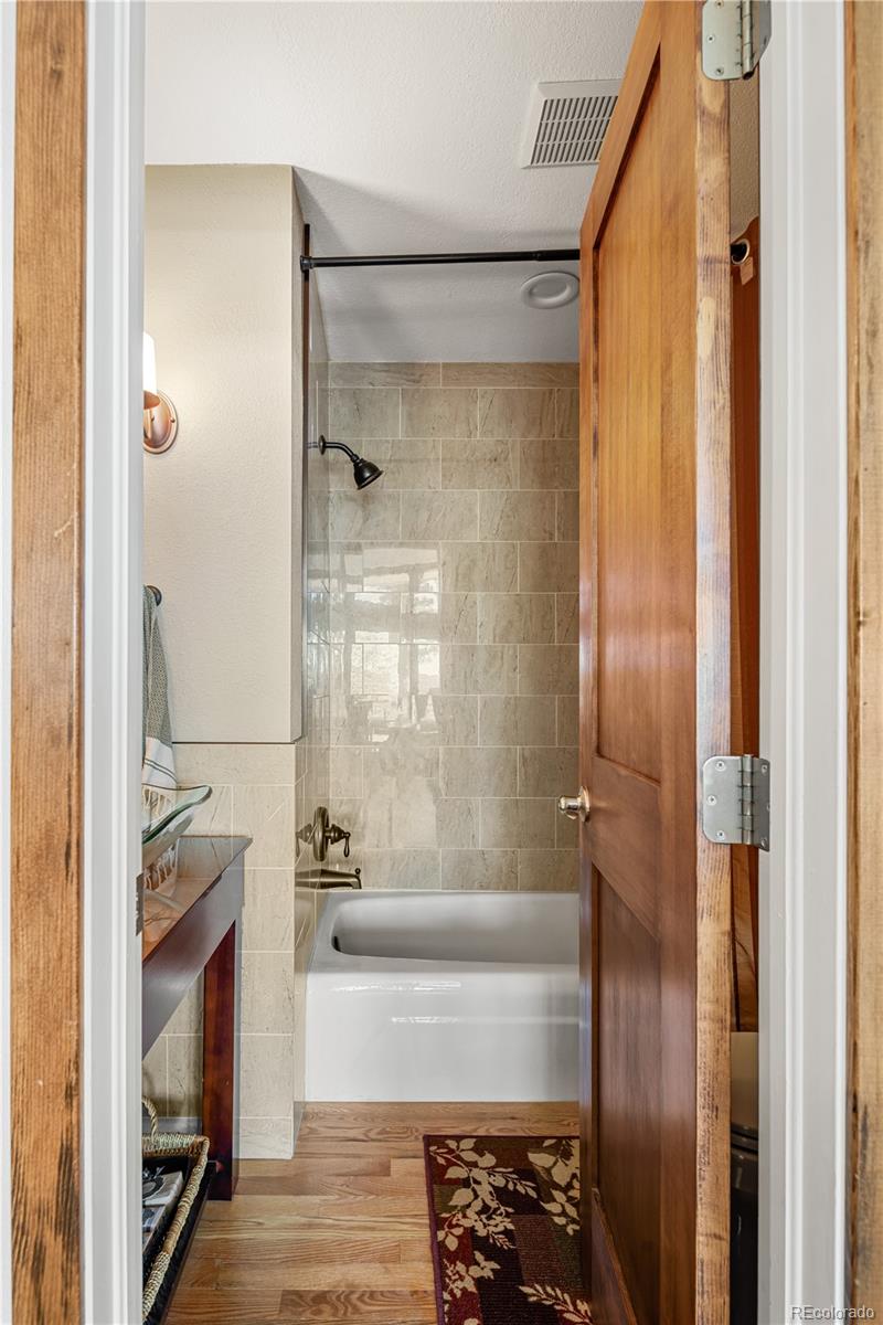 107 Elk Drive Evergreen, CO 80439 - Photo 27 of 45 a bathroom with a bathtub and a shower