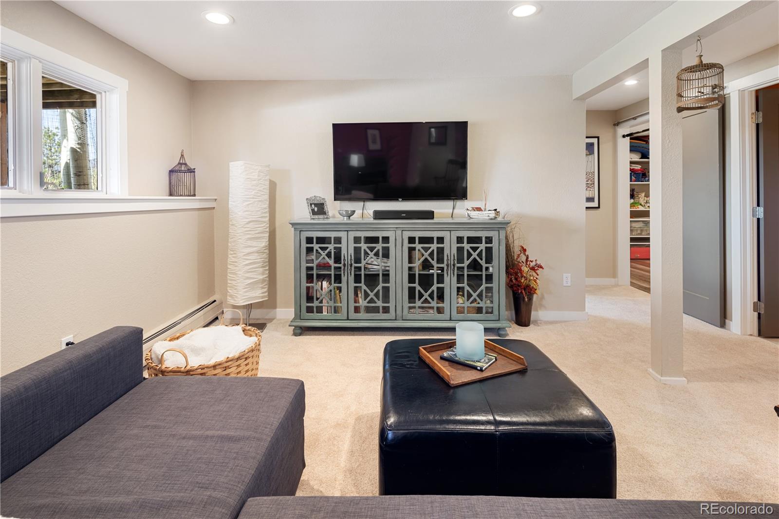 107 Elk Drive Evergreen, CO 80439 - Photo 29 of 45 a living room with furniture and a flat screen tv