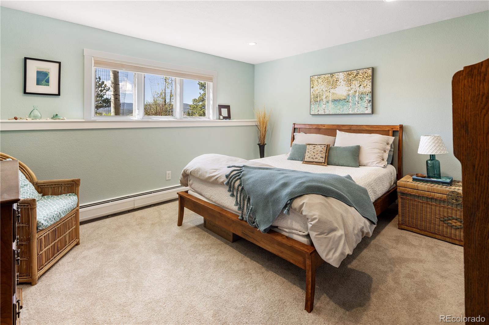 107 Elk Drive Evergreen, CO 80439 - Photo 30 of 45 a bedroom with a bed chair and dresser