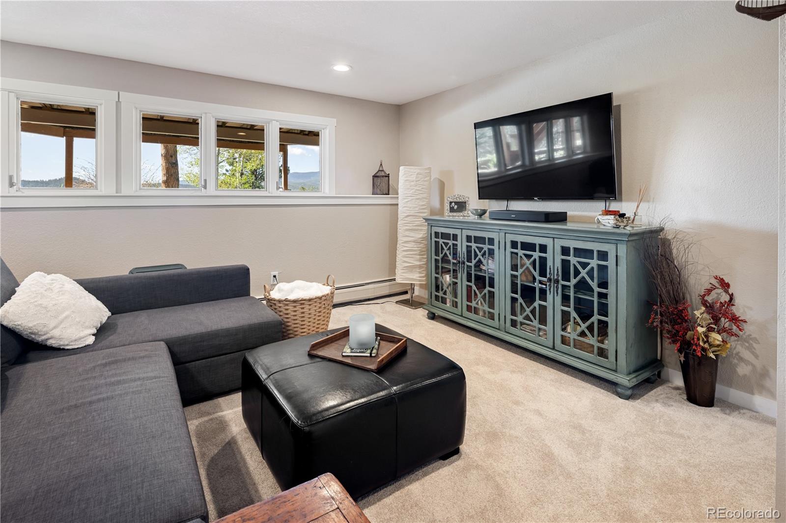107 Elk Drive Evergreen, CO 80439 - Photo 31 of 45 a living room with furniture and a flat screen tv