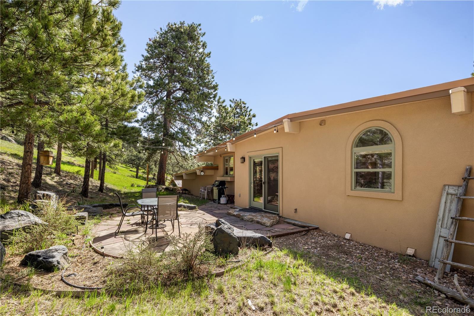 107 Elk Drive Evergreen, CO 80439 - Photo 38 of 45 a backyard of a house with yard and outdoor seating