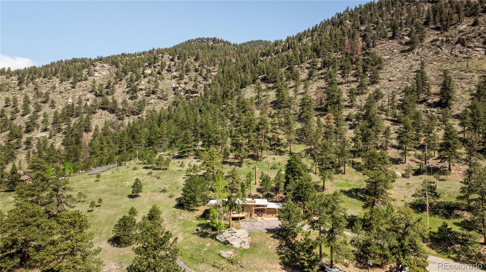 107 Elk Drive Evergreen, CO 80439 - Photo 43 of 45 a view of a large building with mountains in the background