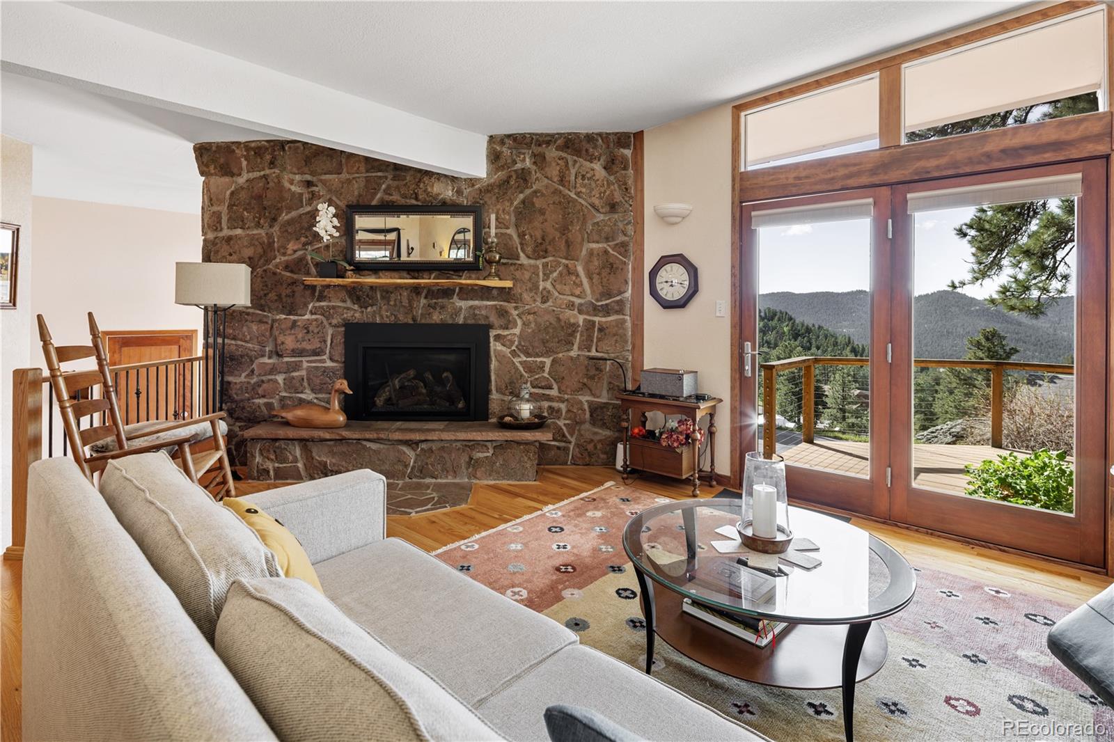 107 Elk Drive Evergreen, CO 80439 - Photo 5 of 45 a living room with furniture and a fireplace