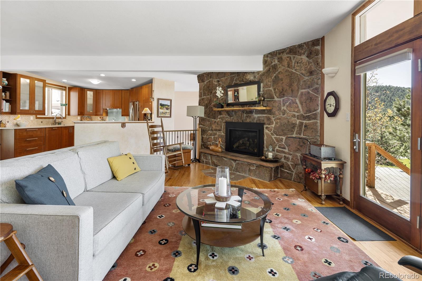 107 Elk Drive Evergreen, CO 80439 - Photo 6 of 45 a living room with fireplace furniture and a floor to ceiling window