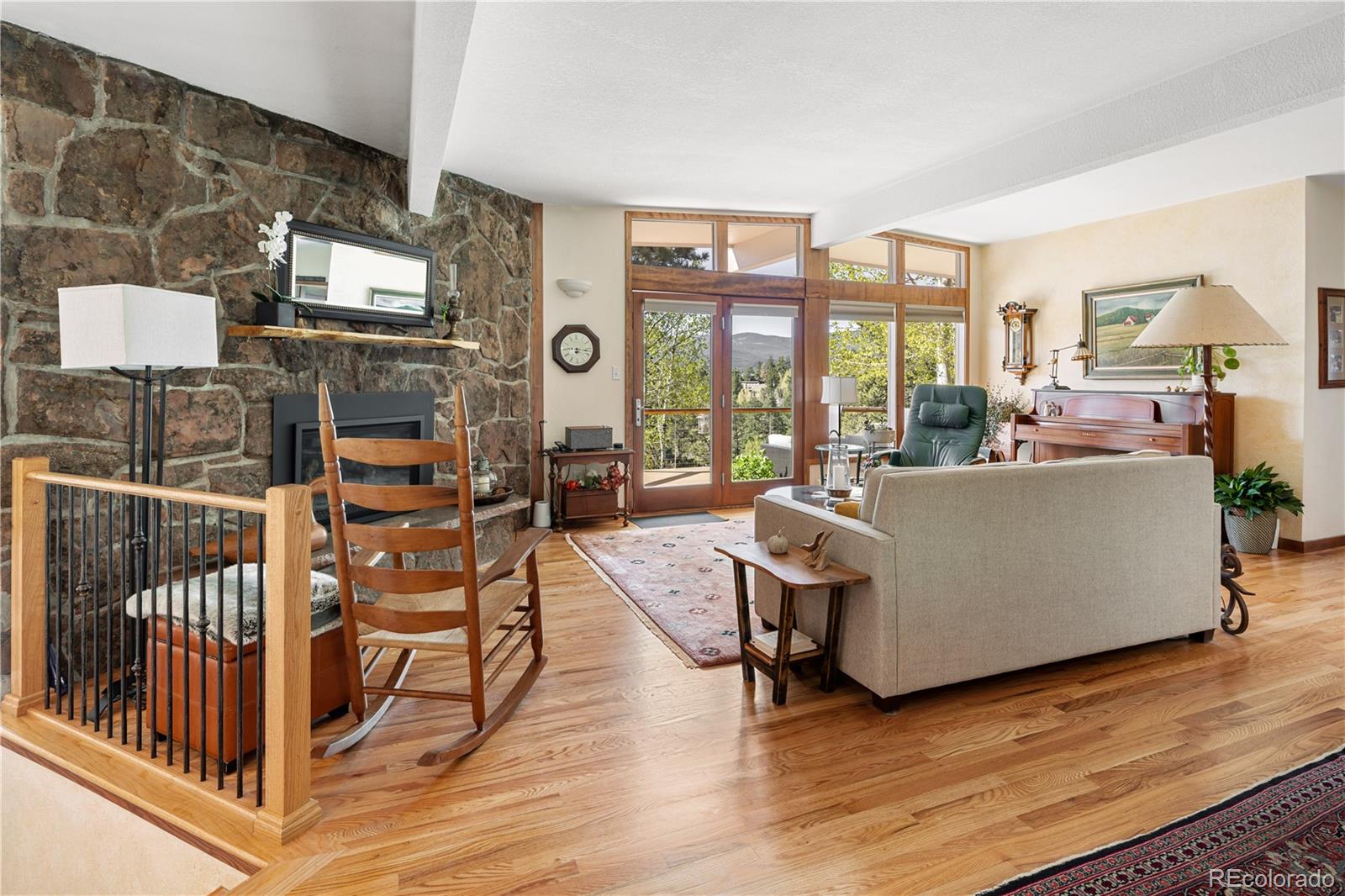 107 Elk Drive Evergreen, CO 80439 - Photo 8 of 45 a living room with furniture and a floor to ceiling window