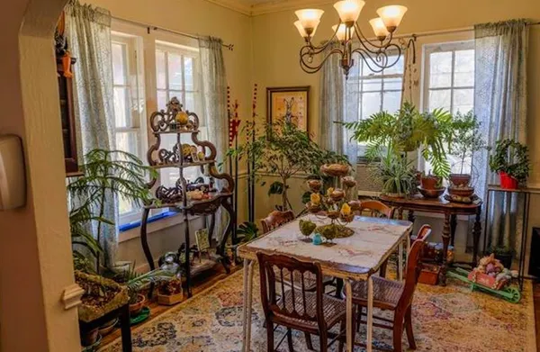 a view of a dining room with furniture and chandelier