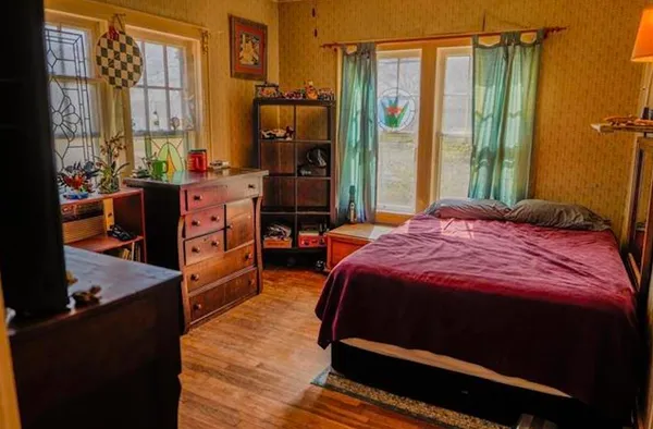 a bathroom with a sink and mirror with window
